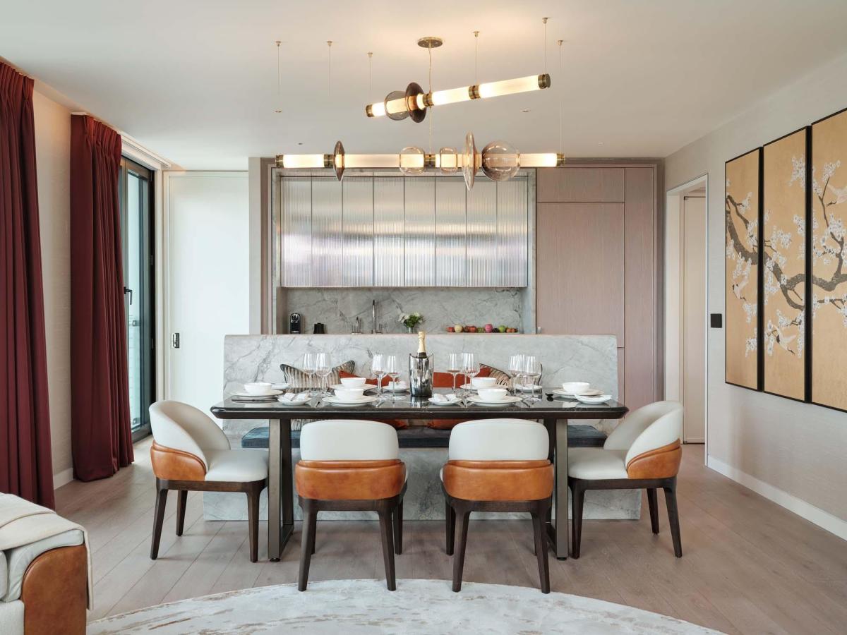 Contemporary long chandelier featuring hand-blown glass in modern dining room