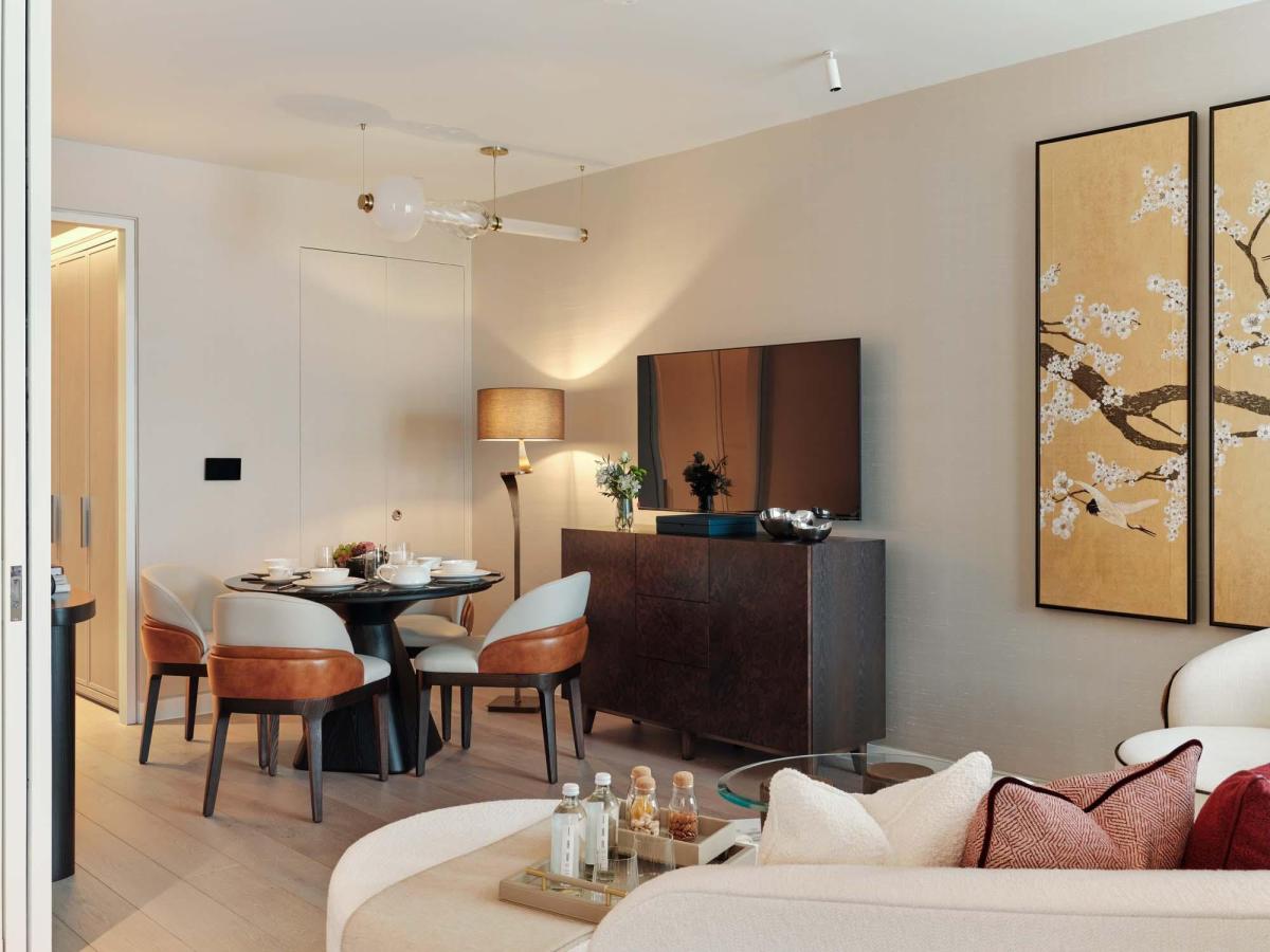 Bespoke chandelier light with brass details above designer dining setting