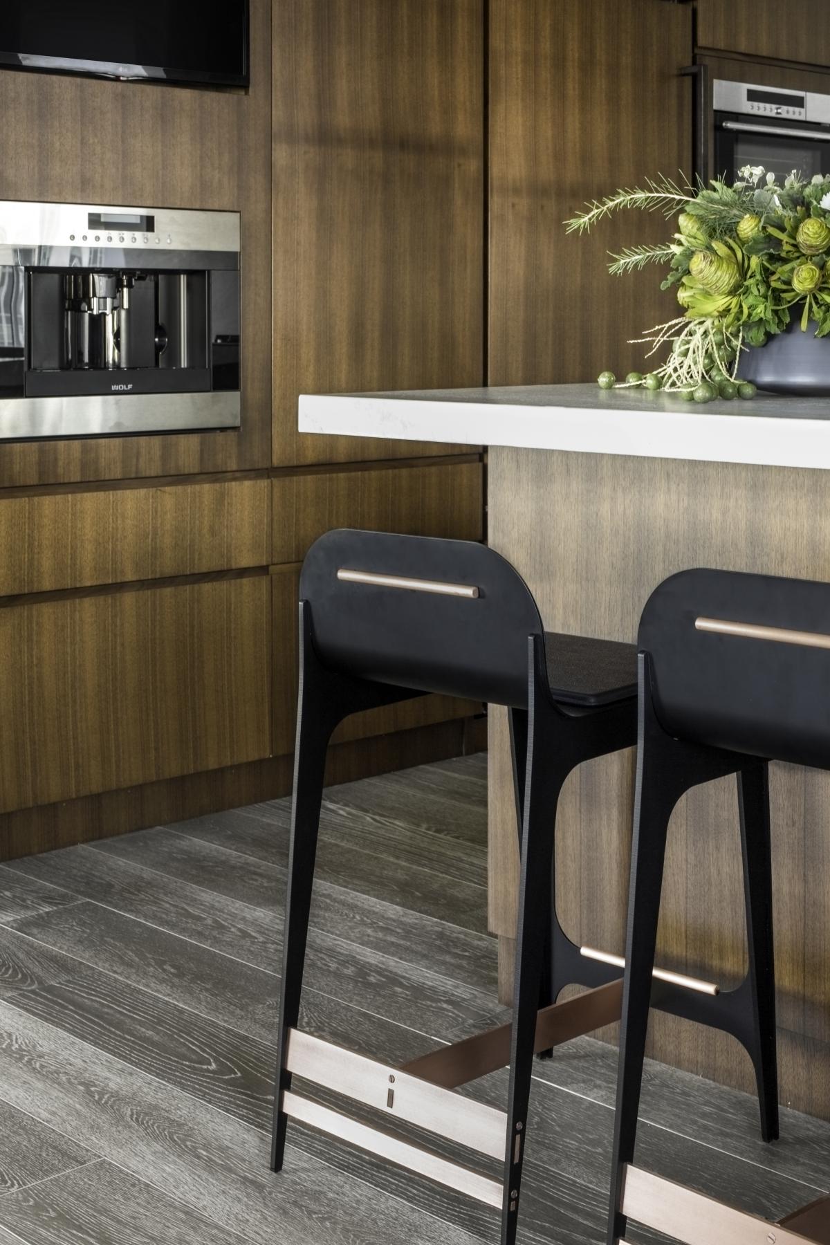 Side view of Gabriel Scott Bardot barstools in Black Nickel, highlighting their sleek profile at a kitchen counter