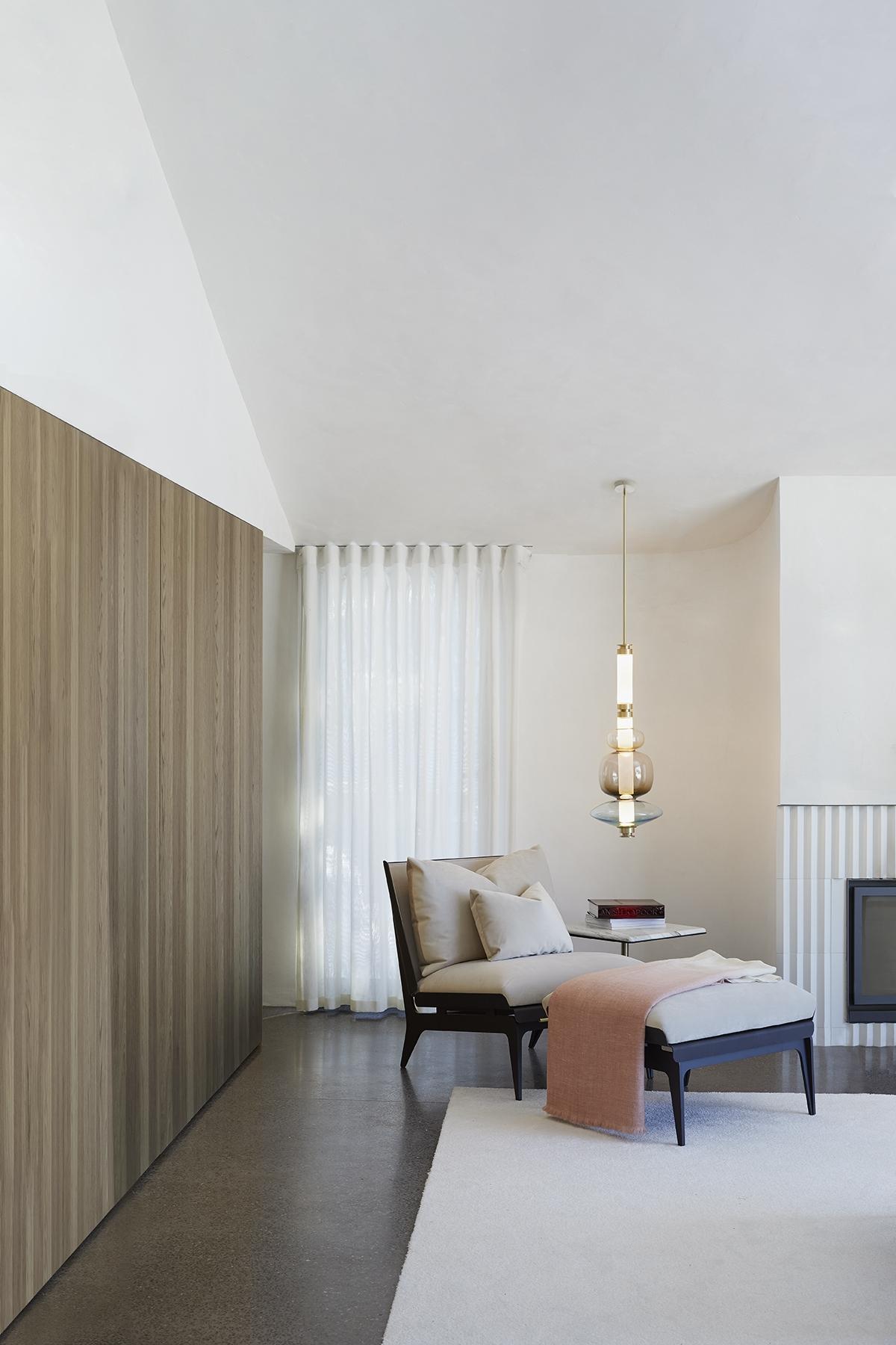 Gabriel Scott's Boudoir Chaise Longue with Luna Glass Pendant Light suspended from the ceiling in minimalist room