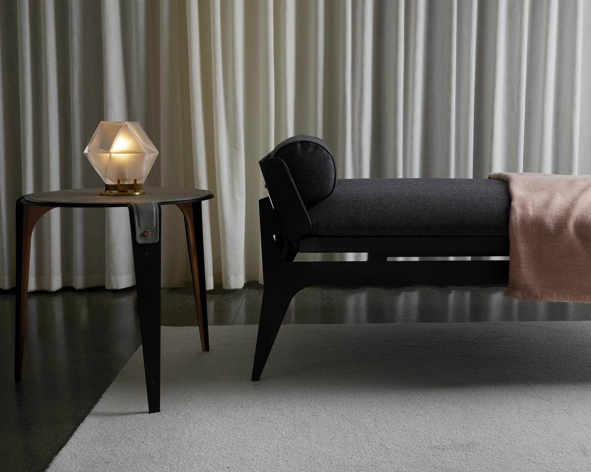 Sleek black Gabriel Scott Bardot daybed paired with geometric Welles desk lamp in contemporary setting