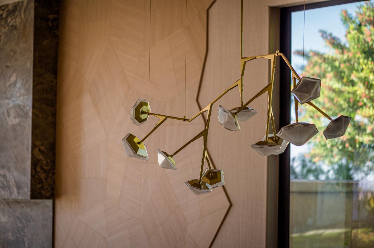 Elegant Myriad long glass chandelier by Gabriel Scott in brass, installed in a luxury interior designed by Bita Interior Design.